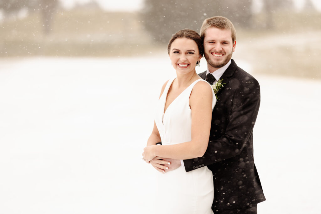 bride and groom outside in snow at woodhaven