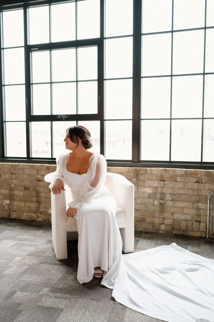Bride sitting on chair at Harvester Square St Cloud Minnesota Wedding venue