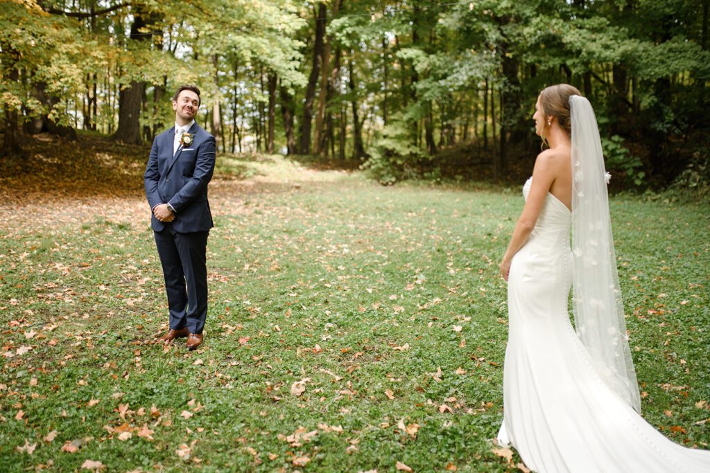 Bride and groom first look at Camp Fire Minnesota wedding venue
