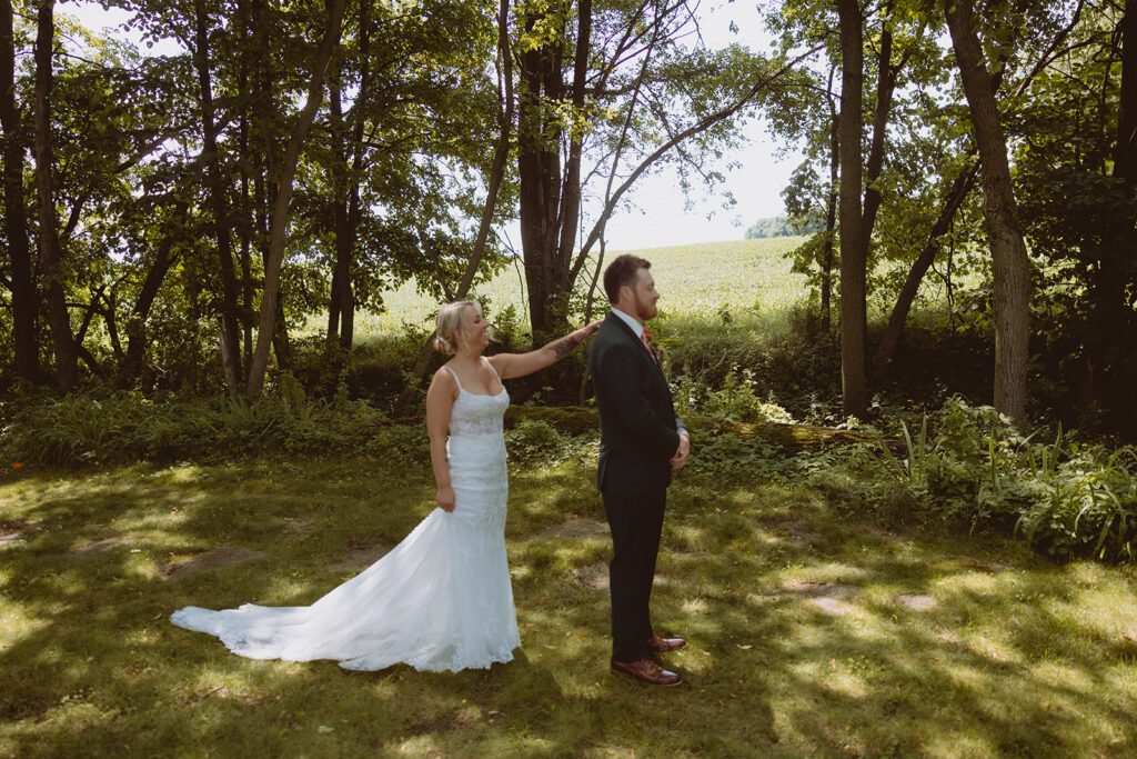 Bride and groom first look at Pondview Farm wedding venue in Cambridge Minnesota